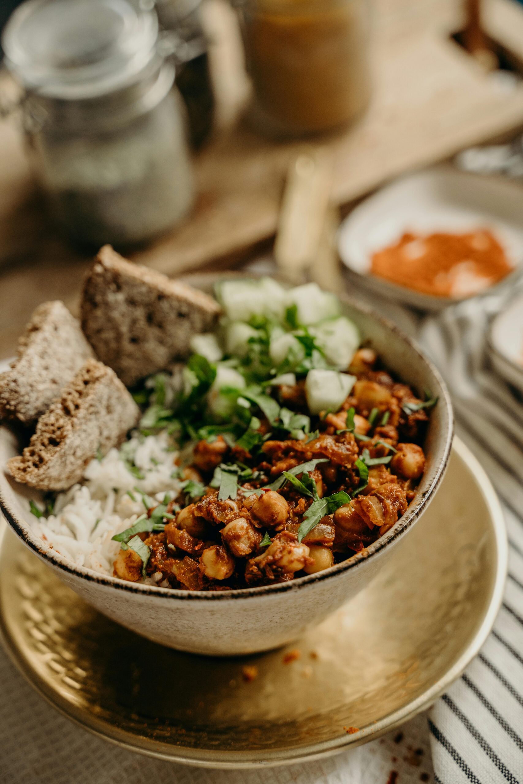 Enjoy a healthy vegan chickpea rice bowl garnished with fresh cucumbers and herbs, perfect for a nutritious dinner.